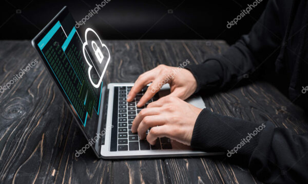 Cropped view of hacker using laptop with cloud and padlock on black